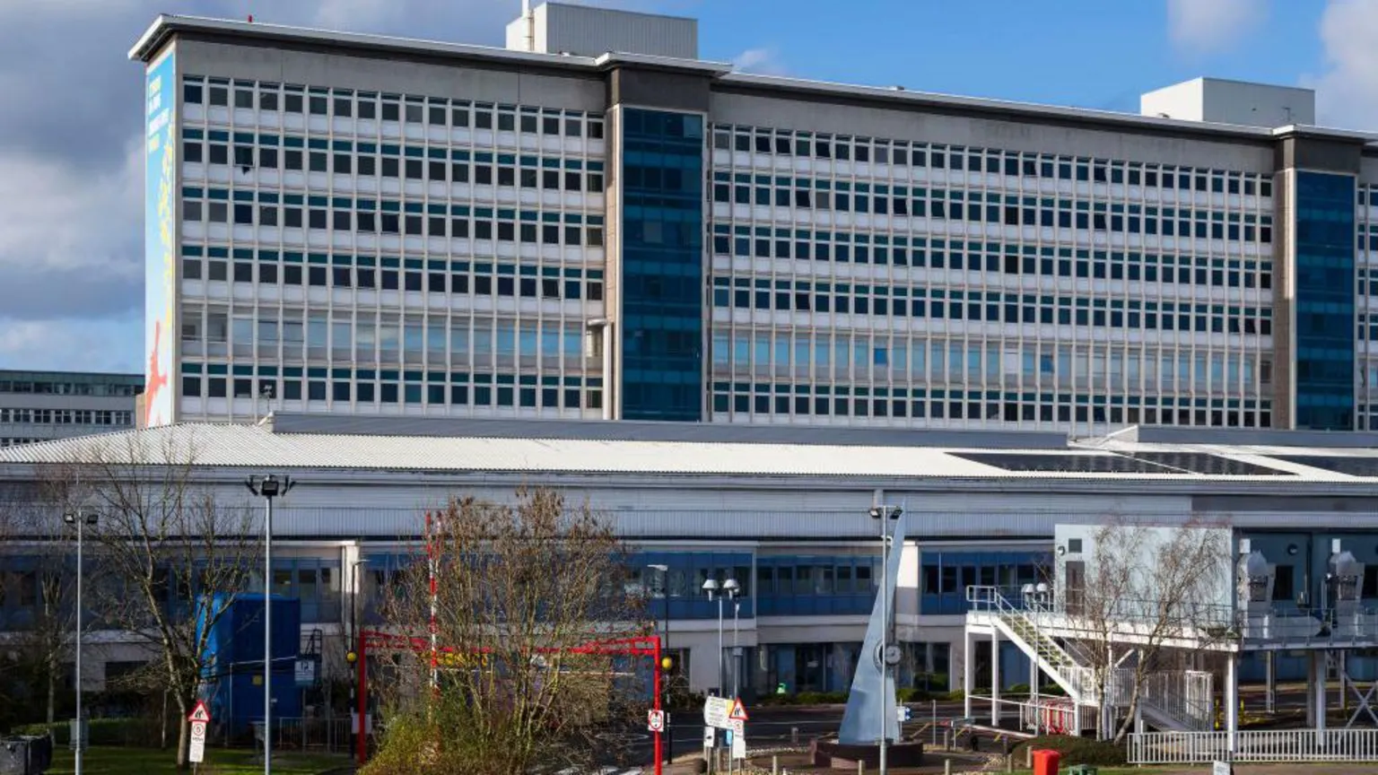 Getty Images University Hospital Wales main building seen from the front outside. A large high-rise rectangular building rises up behind and a two-storey building is visible in front 